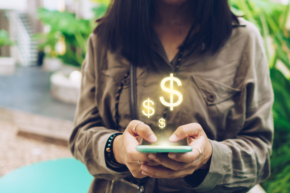 Woman Using Smartphone With Dollar Sign